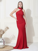 Woman wearing a red evening gown against a white wall.